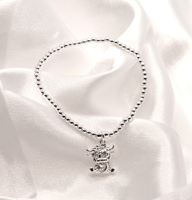 Stretch Charm Bracelet with Silver Coloured Beads and Bonnie Highland Cow Charm