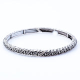 Silver Coloured Designer Bracelet.  Easily slips on - Stetchy Rhodium Plated  Hypoallergenic: Nickel, Lead and Cadmium Free  A great match to wear with our Crystal Pendants and Earrings Delivered in a soft black velveteen pouch