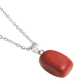 Artisan Natural Stone Single Red Coral Necklace Red Coral Crystal: for Success and Prosperity, also worn for blood circulation and heart health. Crystal drop is 20mm in size Titanium Steel Extension Chain Hypoallergenic: Nickel, Lead and Cadmium Free Delivered in a soft, black, velveteen pouch 