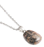 Artisan Natural Stone Single Pink Rhodonite Necklace Pink Rhodonite: for Compassion and Love Crystal drop is 20mm in size Titanium Steel Extension Chain Hypoallergenic: Nickel, Lead and Cadmium Free  Delivered in a soft, black, velveteen pouch